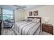 Spacious bedroom with striped bedding and wood flooring at 6145 Sun Blvd # 404, St Petersburg, FL 33715