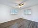 Spacious bedroom with wood-look floors, white walls, and natural light at 2040 N Highland Ave, Clearwater, FL 33755