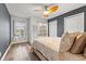 Cozy bedroom with wood flooring, a ceiling fan, and a large window to let in natural light at 214 Cape Harbour Loop # 105, Bradenton, FL 34212