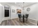 Modern dining room featuring wood flooring, a sleek table, and decorative lighting at 214 Cape Harbour Loop # 105, Bradenton, FL 34212