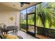 Relaxing screened lanai with views of lush landscaping and a table for outdoor dining at 214 Cape Harbour Loop # 105, Bradenton, FL 34212