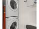 Convenient laundry area featuring a stacked washer and dryer set for space-saving efficiency at 214 Cape Harbour Loop # 105, Bradenton, FL 34212