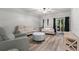 Bright living room featuring modern seating, wood flooring, and sliding glass doors at 214 Cape Harbour Loop # 105, Bradenton, FL 34212