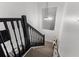 Stylish staircase with black railing and carpeted steps, illuminated by a modern light fixture at 214 Cape Harbour Loop # 105, Bradenton, FL 34212