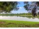 Scenic water view featuring a grassy shoreline, trees and birds flying over the lake at 214 Cape Harbour Loop # 105, Bradenton, FL 34212