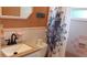 Bathroom with pink tile, vanity and shower/tub combo at 2392 Indigo Dr, Clearwater, FL 33763