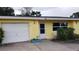 House exterior featuring a garage and landscaping at 2392 Indigo Dr, Clearwater, FL 33763