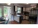 Kitchen with breakfast bar, white cabinets and backyard access at 2392 Indigo Dr, Clearwater, FL 33763