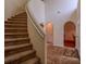 Curved staircase with carpeted steps and a white railing in the foyer at 8303 Torrington Ave, Tampa, FL 33647