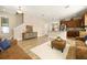 Open living room features hardwood floors, a leather couch, and an island kitchen at 1407 7Th N Ave, St Petersburg, FL 33705