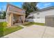 Tan two-story house with a covered patio and detached shed at 1407 7Th N Ave, St Petersburg, FL 33705