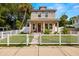 Two-story house with white picket fence and landscaped lawn at 1407 7Th N Ave, St Petersburg, FL 33705
