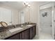 Clean bathroom with double vanity, granite countertop, and a separate tub at 1407 7Th N Ave, St Petersburg, FL 33705