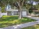 Newly renovated gray house with white garage door at 7694 62Nd N St, Pinellas Park, FL 33781