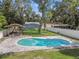 Aerial view of a kidney-shaped pool and backyard with a pergola at 7694 62Nd N St, Pinellas Park, FL 33781