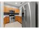 Modern kitchen with stainless steel appliances and wood cabinets at 214 Cape Harbour Loop # 105, Bradenton, FL 34212