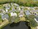 Aerial view of homes and a lake in a residential community at 2203 W Del Webb Blvd, Sun City Center, FL 33573