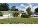 Bright yellow house with a neatly landscaped lawn and driveway at 2392 Indigo Dr, Clearwater, FL 33763