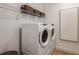 Bright laundry room with Whirlpool appliances and shelving at 13716 Brookside Haven St, Riverview, FL 33578