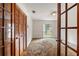 Bedroom with wood closet doors and window at 15904 Nottinghill Dr, Lutz, FL 33548