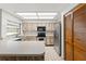 Kitchen features wood cabinets and hex floor at 15904 Nottinghill Dr, Lutz, FL 33548