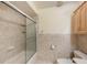 This is a view of a bathroom featuring a bathtub and shower combo with a glass door at 218 N Bay Hills Blvd, Safety Harbor, FL 34695