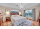 Charming bedroom featuring a chandelier, wood floors and a large window at 218 N Bay Hills Blvd, Safety Harbor, FL 34695