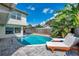 A refreshing in-ground pool and backyard featuring pavers and two lounge chairs for relaxing at 218 N Bay Hills Blvd, Safety Harbor, FL 34695