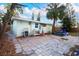 Spacious backyard with a stone-tiled patio, a picnic table and bordered by wood fencing at 2600 1St St, Indian Rocks Beach, FL 33785