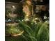 Landscaped front yard with a fountain at night at 2255 Trelain S Dr, St Petersburg, FL 33712