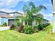 One-story home showcasing landscaping and garage at 31559 Barrel Wave Way, Wesley Chapel, FL 33545