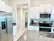 Modern kitchen featuring stainless steel appliances and granite countertops at 31559 Barrel Wave Way, Wesley Chapel, FL 33545