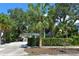 Exterior of a charming house nestled among palm trees and lush greenery at 785 5Th S St, Safety Harbor, FL 34695