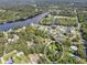 Aerial view of a home nestled along a waterway, surrounded by lush greenery at 10824 Palmetto St, Riverview, FL 33569