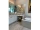 Bright bathroom features double sinks, makeup vanity, soaking tub, and neutral tile floors at 16015 Cape Coral Dr, Wimauma, FL 33598
