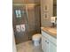 Bathroom features a standing shower, toilet, and white vanity with countertop sink at 16015 Cape Coral Dr, Wimauma, FL 33598