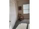 Cozy bedroom with rocking chair and sunlight streaming through the window at 16015 Cape Coral Dr, Wimauma, FL 33598