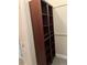 Custom closet with wooden shelving and cabinetry, offering ample storage space for clothes and accessories at 16015 Cape Coral Dr, Wimauma, FL 33598
