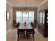 Formal dining room featuring a large dining table, elegant chandelier, and tile floors at 16015 Cape Coral Dr, Wimauma, FL 33598