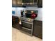 Modern kitchen featuring stainless steel appliances and white backsplash at 16015 Cape Coral Dr, Wimauma, FL 33598