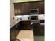 Gourmet kitchen boasts granite countertops and stainless steel appliances at 16015 Cape Coral Dr, Wimauma, FL 33598