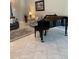 Open-concept living room showcasing a piano, comfortable seating, and tiled flooring at 16015 Cape Coral Dr, Wimauma, FL 33598