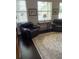 Inviting living room featuring hardwood floors, a large rug, and comfortable chairs at 16015 Cape Coral Dr, Wimauma, FL 33598