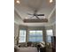 Main bedroom boasts tray ceilings, ceiling fan, lots of natural light, and lovely lake views at 16015 Cape Coral Dr, Wimauma, FL 33598