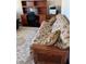 A functional office space with a wooden desk, black office chair, sofa, and a printer on a wooden drawer at 16015 Cape Coral Dr, Wimauma, FL 33598