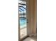View from interior shows screened-in lanai with inviting pool and beautiful lake view at 16015 Cape Coral Dr, Wimauma, FL 33598