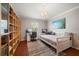Well-lit bedroom features built in bookshelves, work desk, and neutral paint at 17905 Machair Ln, Land O Lakes, FL 34638