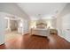 Bright main bedroom with vaulted ceiling, hardwood floors, and ensuite bathroom at 17905 Machair Ln, Land O Lakes, FL 34638