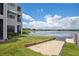 Lakeside view of private community backyard with boat launch and lake access on a sunny day at 3127 W Sligh Ave # 204B, Tampa, FL 33614