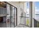 View of lake from balcony with tiled floor and sliding glass doors to the living area and kitchen at 3127 W Sligh Ave # 204B, Tampa, FL 33614